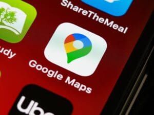 Christopher Berry, Google Business Profile management consultant, showing a smartphone with a verified Google Maps listing and a 5-star rating.