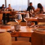 Restaurant marketing consultant discussing local SEO and growth strategies with clients in a dining room setting.