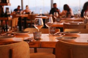 Restaurant marketing consultant discussing local SEO and growth strategies with clients in a dining room setting.