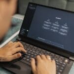 Consultant reviewing AI search results and website analytics on a laptop, representing AI search optimization and visibility strategy.