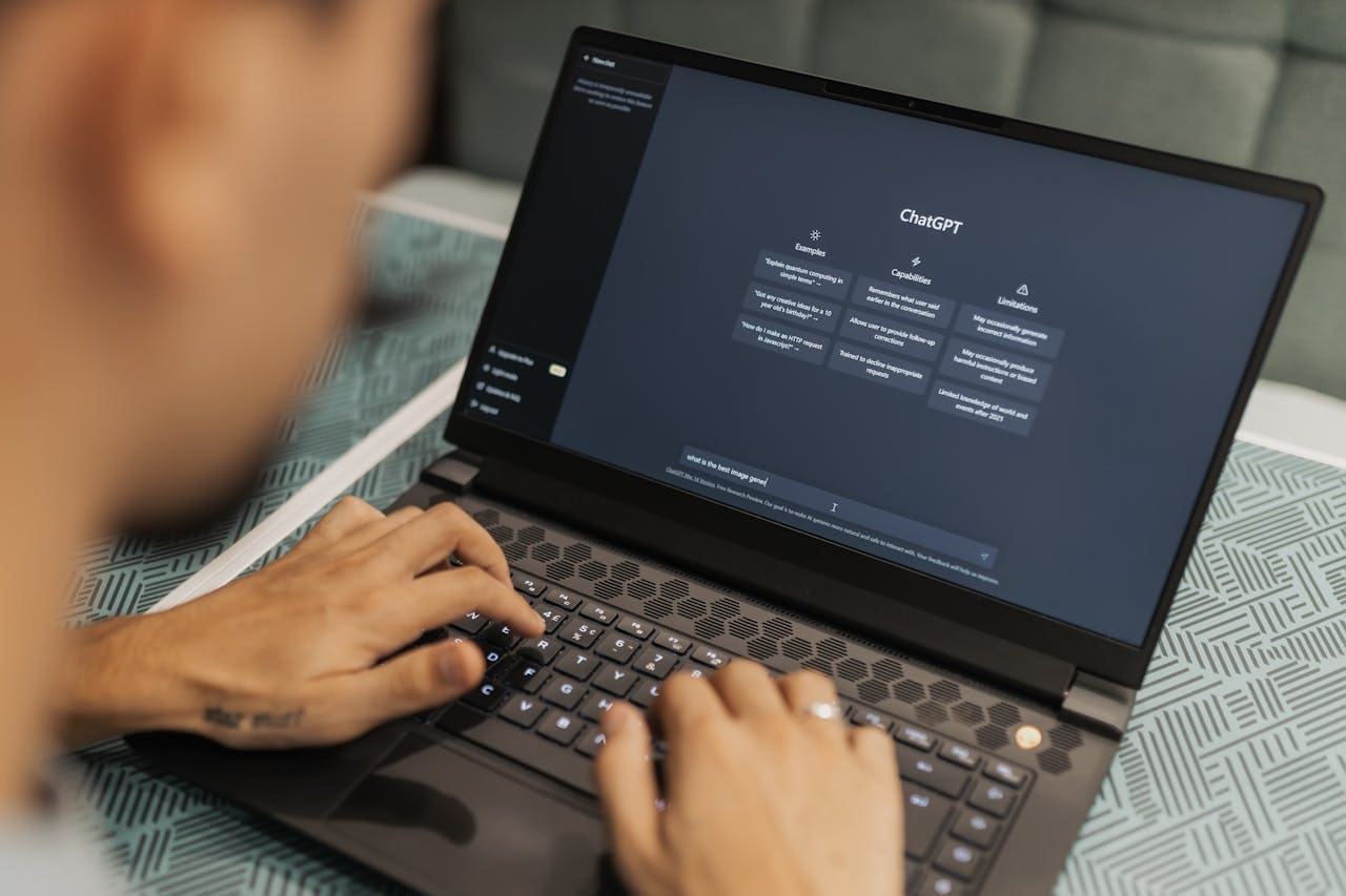 Consultant reviewing AI search results and website analytics on a laptop, representing AI search optimization and visibility strategy.